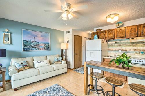 a living room with a white couch and a kitchen at Pool and Boat Slip Available Osage Beach Condo! in Osage Beach