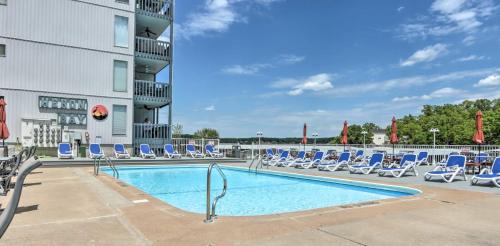 a swimming pool with lounge chairs and a hotel at Pool and Boat Slip Available Osage Beach Condo! in Osage Beach