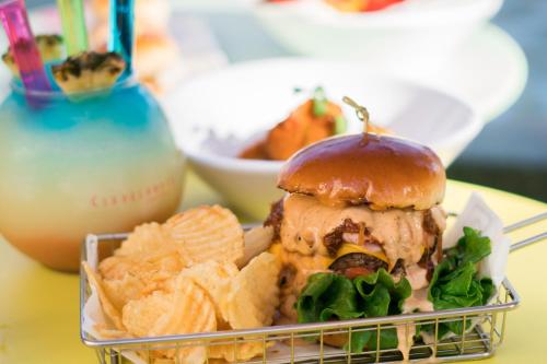 a plate of food with a sandwich and chips at Clevelander Hotel in Miami Beach
