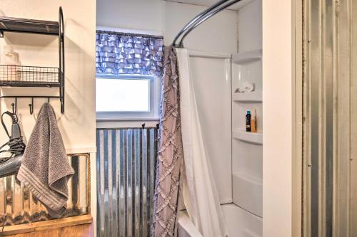 a bathroom with a shower and a shower curtain at Lakefront Gem with Screened Porch and Game Room! in Shell Knob