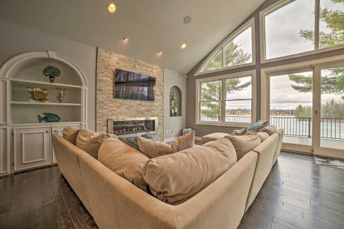 a large living room with a couch and a fireplace at Luxe Waterfront Home with Private Lake Access! in West Branch