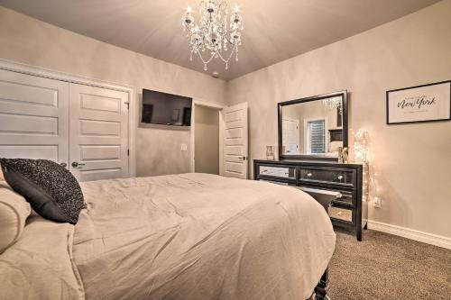 a bedroom with a bed and a dresser and a mirror at Luxe Waterfront Home with Private Lake Access! in West Branch