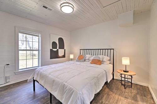 a white bedroom with a large bed and a window at Idyllic Fayetteville Home - Walk to UA Campus! in Fayetteville