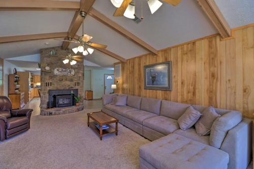 a living room with a couch and a fireplace at Scenic Riverview Getaway with Screened Porch! in Norfork