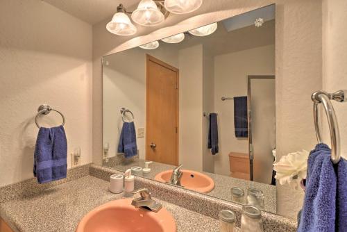 a bathroom with a sink and a mirror at Scenic Riverview Getaway with Screened Porch! in Norfork