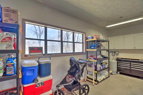 a kitchen with a stroller in a room with a window at Scenic Riverview Getaway with Screened Porch! in Norfork