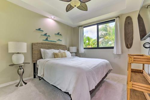 a bedroom with a bed with birds on the wall at Bright and Airy Lahaina Condo - Walk to Beach! in Kahana