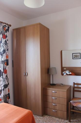 a bedroom with a cabinet and a dresser and a bed at APPARTAMENTI ZUCCALE - A 200 mt dalla spiaggia in Capoliveri