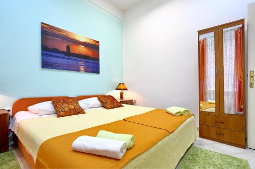 a bedroom with a large bed with two towels on it at Apartment City Center Dragica in Zadar