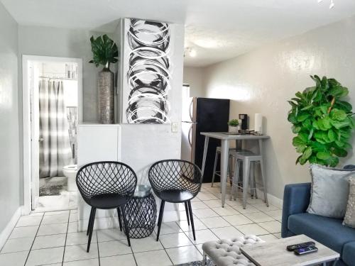 a living room with a blue couch and chairs at Ultra Glam Apartment 6 Miles From Hard Rock Stadium and Casino in Hollywood