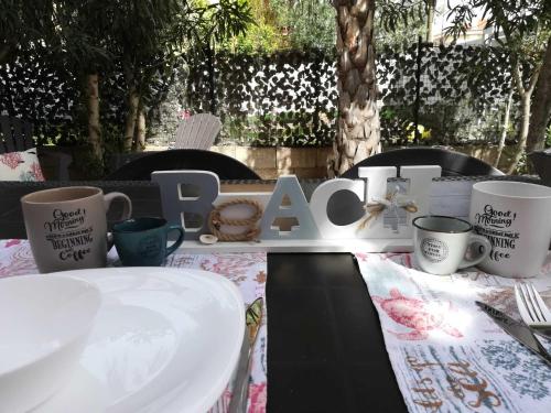 奧爾比亞的住宿－APPARTAMENTO CORALLO with PRIVATE GARDEN，一张桌子,上面有杯子和标志,上面写着spa