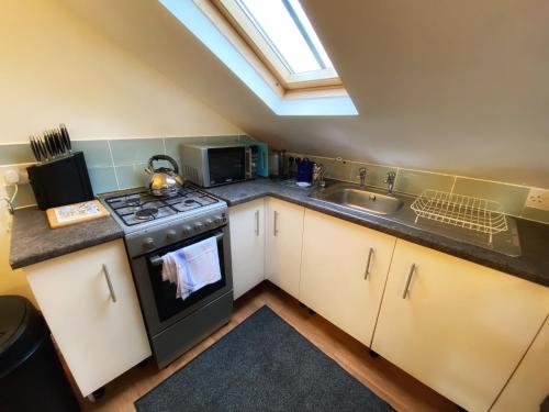a kitchen with a stove and a sink at Mandy's Cottage Lanehead - Rural Escape in Bishop Auckland