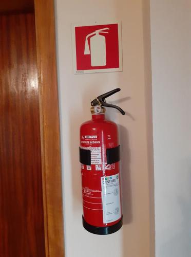 a fire hydrant is hanging on a wall at Casa Grilo in Geres