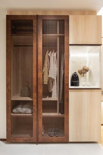 a wooden cabinet with two cages in it at QOYA Hotel Curitiba, Curio Collection by Hilton in Curitiba