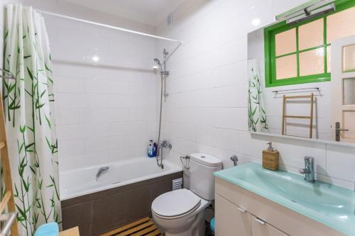 a bathroom with a toilet and a tub and a sink at Be Local - Flat with 1 bedroom and terrace in Moscavide - Lisbon in Lisbon
