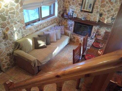 a living room with a couch and a fireplace at Luxury Villas Chrysa Private Pool & Spa in Nafplio