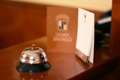 a silver object sitting on a table next to a box at Locanda San Paolo in Monza