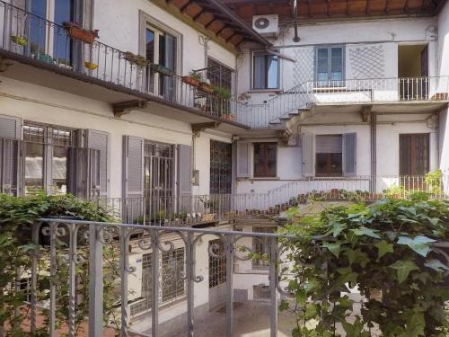 an apartment building with balconies and a courtyard at Locanda San Paolo in Monza