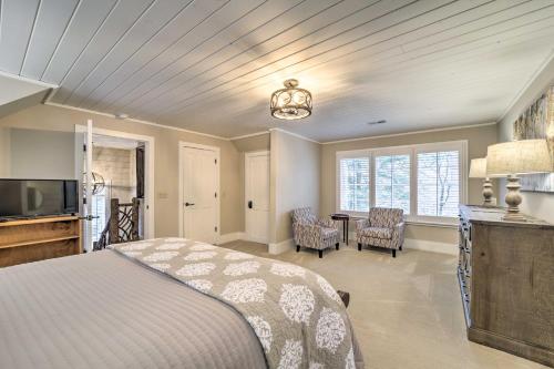 a bedroom with a bed and a table with chairs at Beautiful Trillium Home Next to Waterfall! in Cashiers