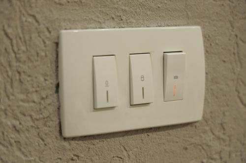 a light switch on a wall with the word light at Apartment Alexandra in Budva