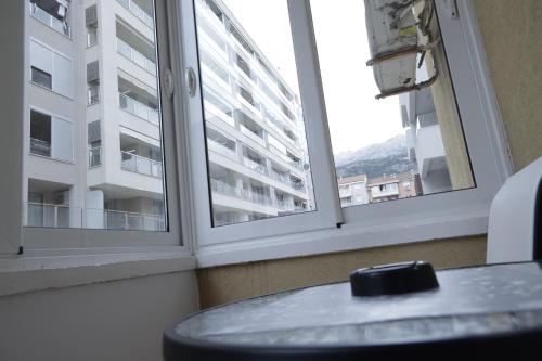 a room with two windows and a table with a view at Apartment Alexandra in Budva