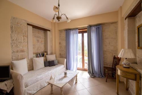 a living room with a couch and a table at Kritamos Villa & Apartments in Kamilari