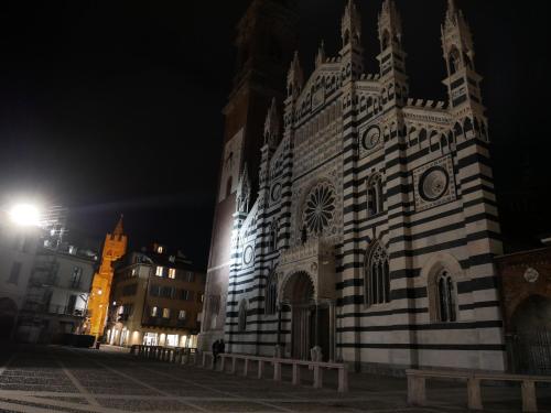 a large building with a clock tower at night at Locanda San Paolo in Monza