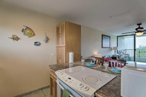 a kitchen with a stove and a counter top at Hilo Condo with Pool Steps from Carlsmith Beach Park in Hilo