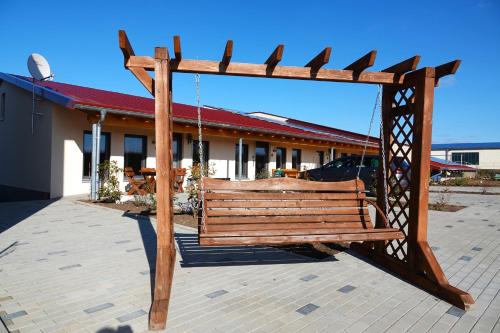 a wooden swing in front of a building at Weinbergshof Rickel in Kitzingen
