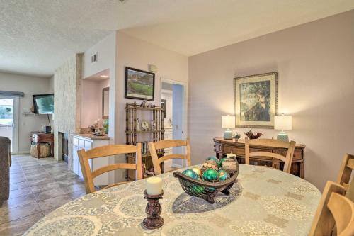 a dining room and kitchen with a table and chairs at Palm Desert Country Club Home with Pool Access! in Palm Desert
