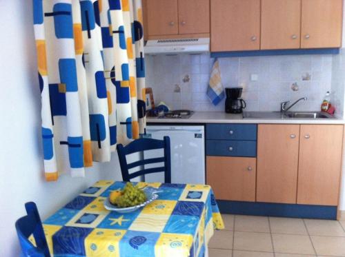 a kitchen with a table with a plate of fruit on it at Stolidi in Adamas