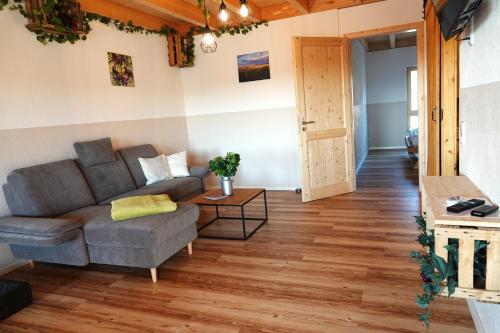 a living room with a couch and a table at Weinbergshof Rickel in Kitzingen