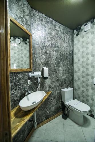 a bathroom with a sink and a toilet at Four Seasons In Carpathians in Migovo