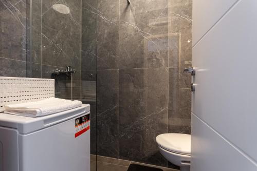 a bathroom with a toilet and a shower at Botan Apartment in Split