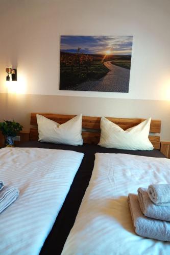 two beds sitting next to each other in a room at Weinbergshof Rickel in Kitzingen