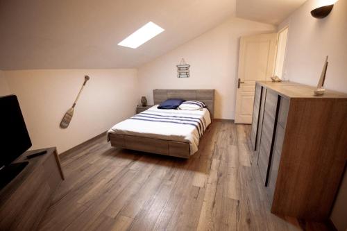 a bedroom with a bed and a television in it at Entre Terre et Mer in Marsillargues