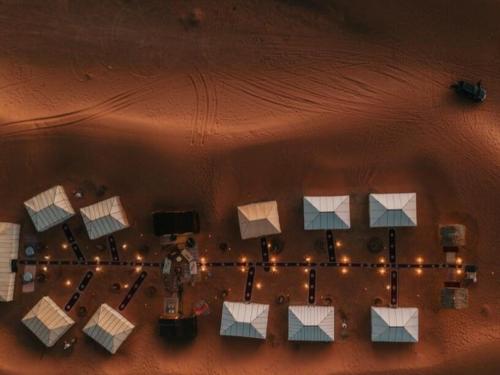 an overhead view of a group of tables and lights at Merzouga Desert Luxury Camp in Merzouga