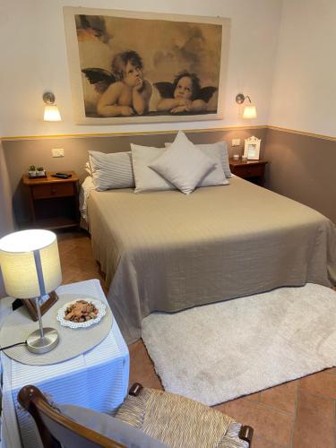 a bedroom with a bed and a table with a plate of food at Valle dei Mulini B&B in Marciana