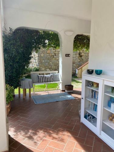 a patio with a bench and a table at Valle dei Mulini B&B in Marciana