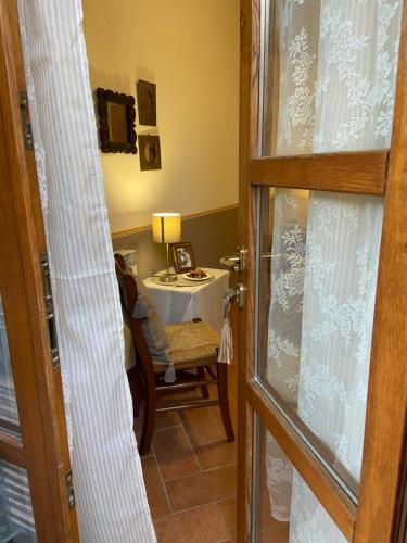 a room with a table and a chair and a door at Valle dei Mulini B&B in Marciana