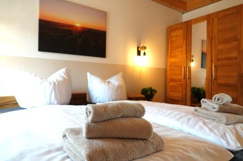 a room with a bed with towels on it at Weinbergshof Rickel in Kitzingen