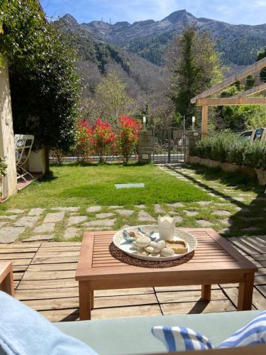 a wooden table with a plate of food on it at Valle dei Mulini B&B in Marciana