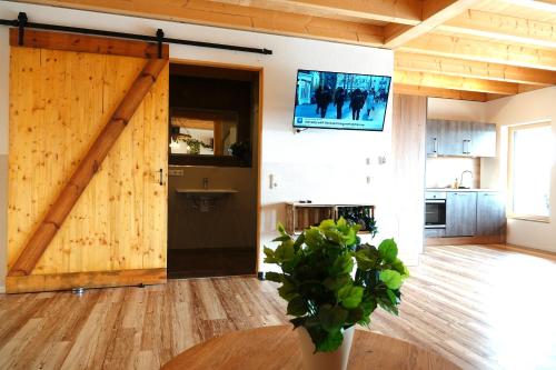 a room with a sliding barn door in a kitchen at Weinbergshof Rickel in Kitzingen
