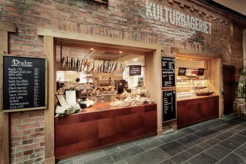 a store front of a brick building with a bakery at U&Me; BW Signature Collection in Umeå