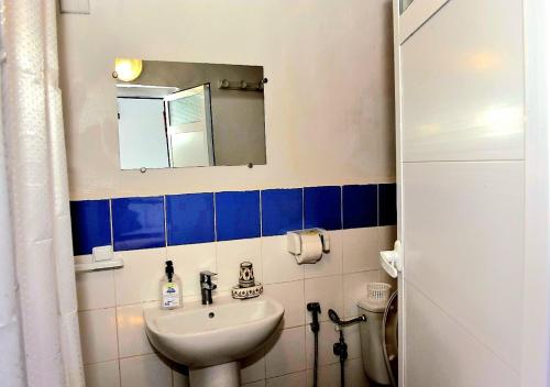 a bathroom with a sink and a mirror at Appart, Hotel & Café Agadir in Essaouira