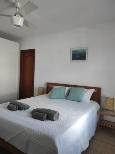a bedroom with a bed with two pillows on it at Laylas Beach Art House in El Cotillo