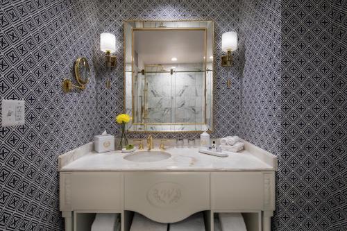 a bathroom with a white sink and a mirror at Willard InterContinental Washington, an IHG Hotel in Washington