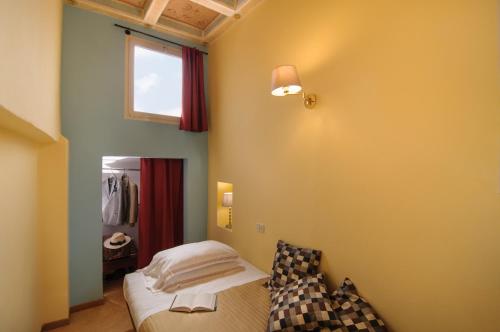 A bed or beds in a room at Hotel Cardinal of Florence - recommended for ages 25 to 55