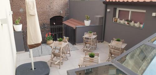 a balcony with chairs and a table with plants at Catania Castle affittacamere di Amato G in Catania