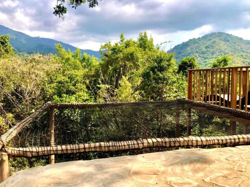 a bird cage with trees and mountains in the background at Hotel Minca - La Casona in Minca